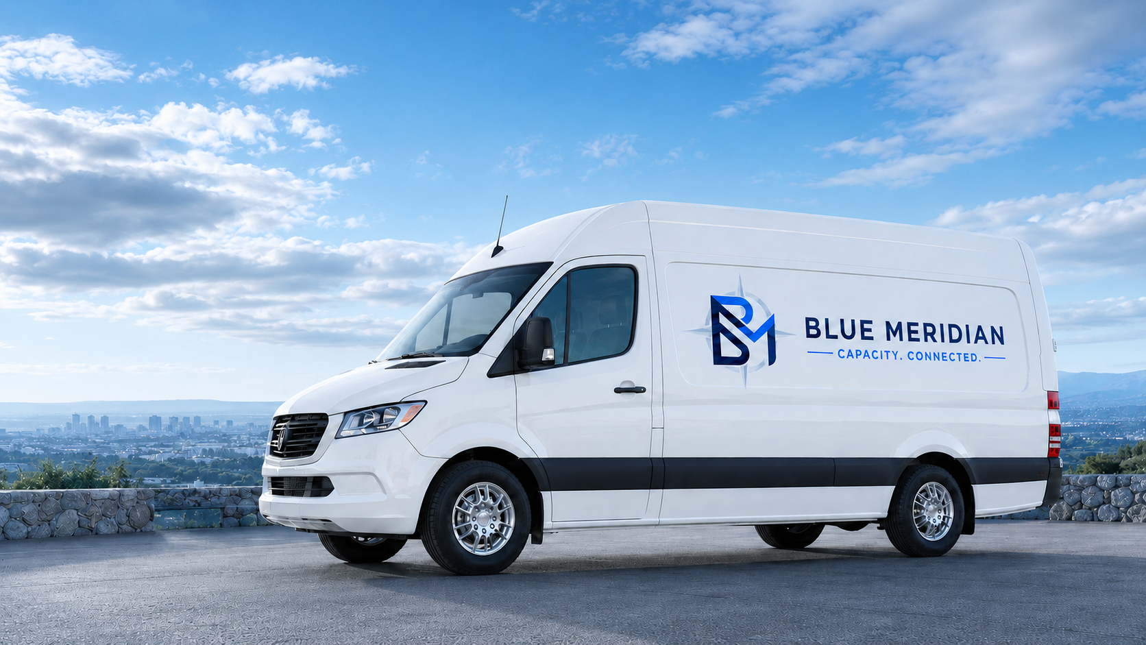 A full Blue Meridian cargo van parked beneath a beautiful blue and white sky
